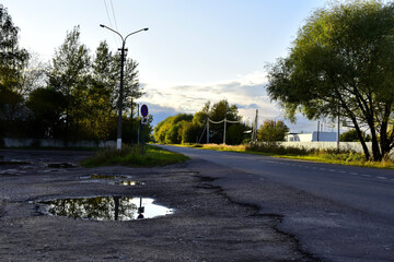 the last rays of the sun at sunset illuminate the road in the village