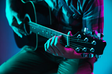 Close up of guitarist hand playing guitar, macro. Concept of advertising, hobby, music, festival,...