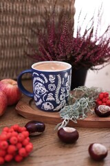 cup of coffee and plants on the wooden background, autumn mood, fall