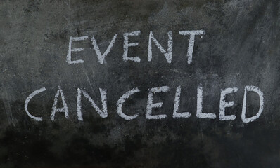 Event Cancelled Phrase Written on Blackboard with White Chalk
