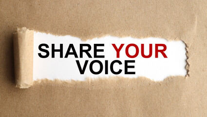 share your voice, text on white paper on torn craft paper