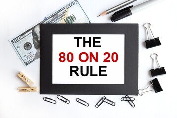 THE 80 ON 20 RULE. TEXT ON WHITE PAPER in a black frame on a light background near the dollar bill