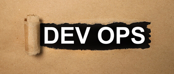 Obraz premium DevOps - development operations lifecycle of automation and monitoring at all steps of software construction. SEO Engineering Business Digital Innovation API concept.text on black paper on torn paper