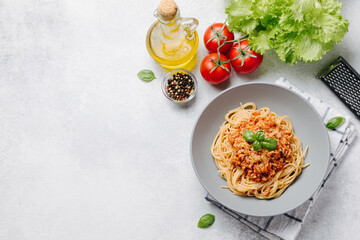 Traditional italian pasta spaghetti with bolognese meat sauce and parmesan on a light concrete, stone background