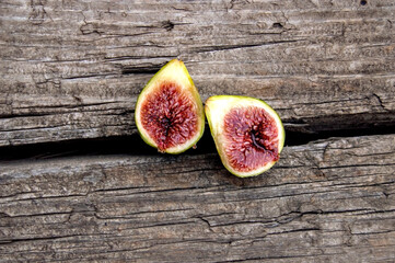 Two halves of figs on old wood