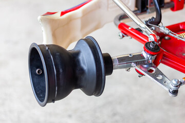 Obraz premium front wheel spindle axle and bracket or hubs of mini racing car sports go kart or scooter during park at service station after finish competition