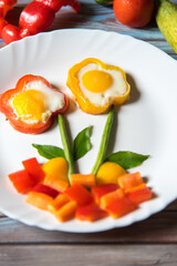 Close up of poached eggs and vegetables in a white plate with use of selective focus. Flower food art.