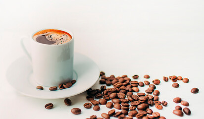 small cup of  hot coffee espresso and brown beans near on the white background