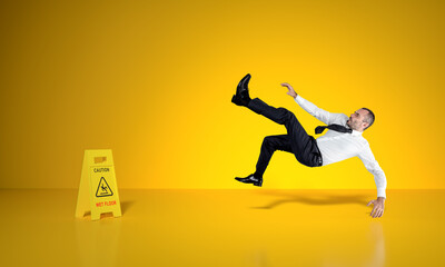 Fototapeta na wymiar businessman slips on wet floor