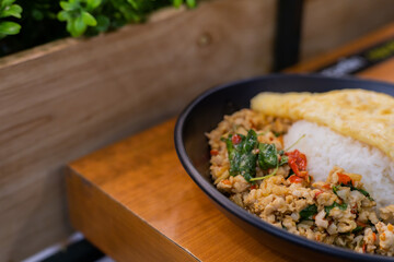 Rice with stir fried pork and basil topped with thai omelette.