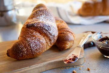 Fresh baked sweet croissants with jam or honey for breakfast
