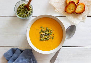 Pumpkin cream soup with seeds, pistachios, sesame seeds and spices. Healthy eating. Vegetarian food.