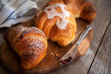 Fresh baked sweet croissants with jam or honey for breakfast