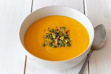 Pumpkin cream soup with seeds, pistachios, sesame seeds and spices. Healthy eating. Vegetarian food.