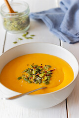 Pumpkin cream soup with seeds, pistachios, sesame seeds and spices. Healthy eating. Vegetarian food.