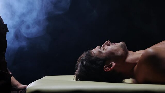 Chiropractic therapy in the studio - the client lying down on the couch in the begining of the therapy