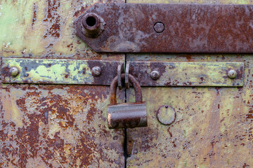 Old door with an old lock. Old padlock.