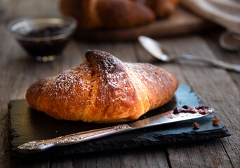 Fresh baked sweet croissants with jam or honey for breakfast