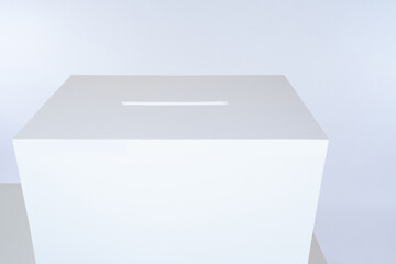 On the table is a white box with a slot. A box to collect the forms. Conducting a public opinion poll. The ballot box in the elections. Collect feedback on the work done.