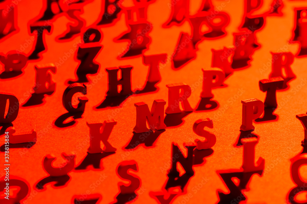 Fototapete black and red background from the letters of the english alphabet. background of latin letters in fo