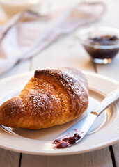 Fresh baked sweet croissants with jam or honey for breakfast