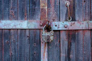 Old door with an old lock. Old padlock.