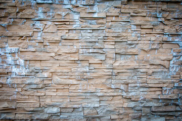 Rough texture of rock wall, The wall has a specific stone pattern.