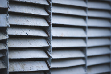 Closeup ventilation grill on the street. Old rusty ventilation grill in front of an industrial building.