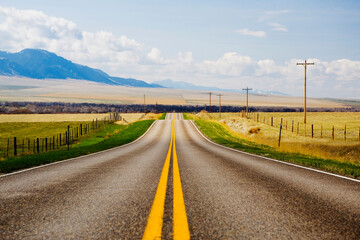 Fototapeta na wymiar Road passing through fields, Montana, USA