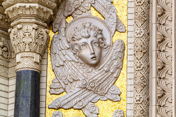Angel face. Decorative stone detail on the facade of the Navy Cathedral of St. Nicholas in Kronstadt, St. Petersburg, Russia