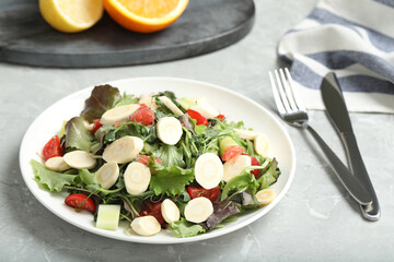 Delicious carrot salad served on grey table, closeup