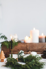 Making simple stylish christmas wreath with cedar branches, holiday  advent