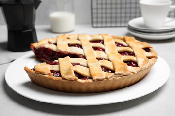 Delicious fresh cherry pie on light grey marble table