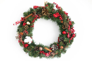 Christmas wreath hanging on white wall in house
