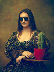 Cactus friend. Young woman as Mona Lisa, La Gioconda isolated on dark green background. Retro style, comparison of eras concept. Beautiful female model like classic historical character, old-fashioned