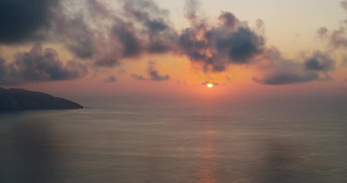 Sunset over sea on ionian Island in Geece. Slow moving clouds above