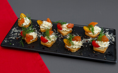 Blooming pelargonium flowers on a background of a house in the city. Landscaping of cities. Flower beds in the city. Pelargonium in urban landscaping. Floral decorations from pelargonium flowers