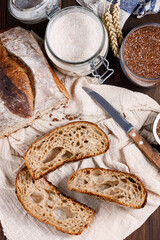 Slices of chopped buckwheat bread on a wooden dark table. Organic grain wholemeal sourdough bread. Top view