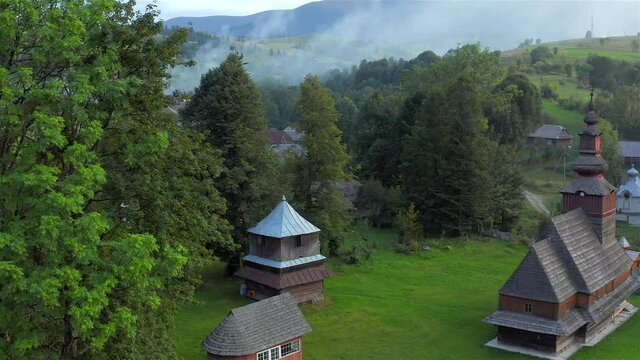 Aerial view of old wooden church in Pylypets, Carpathian village, Ukraine