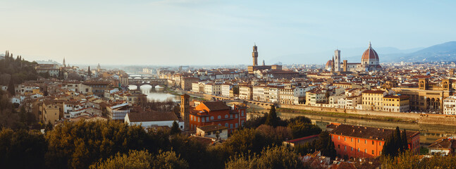 Sunset winter panorama of Florence, Italy, in golden sunlight, with the Arno river and the dome of the cathedral of Santa Maria del Fiore