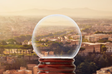Panorama of Rome on a summer sunny morning with mountains in the background through a glass transparent ball
