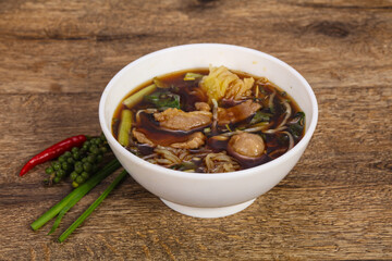 Thai style soup with meat and mushrooms
