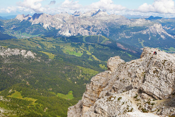 Fototapeta na wymiar Hikers and wonderful panorama in italian Alps