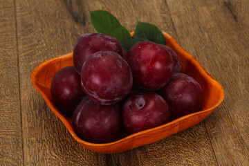 Plum heap in the wooden basket
