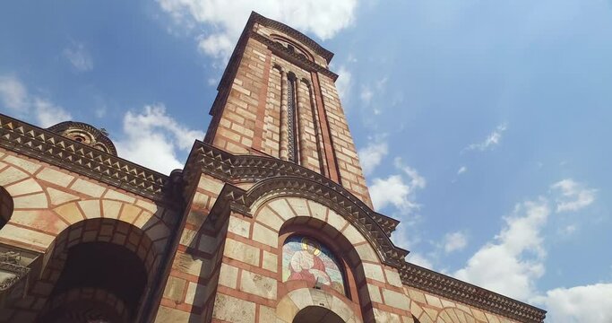 Belgrade, Serbia. Young Woman Walking on Stairs Under St. Marks Orthodox Church Under Summer Sky, Low Angle