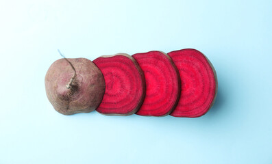 Cut fresh red beet on light blue background, flat lay