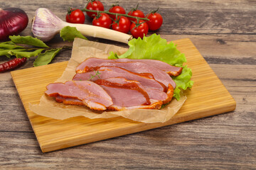 Sliced smoked duck breast served salad