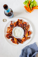 Barbecue chicken wings with carrots, celery and white sauce. Grill. Recipe.