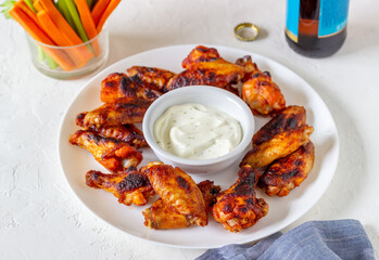 Barbecue chicken wings with carrots, celery and white sauce. Grill. Recipe.