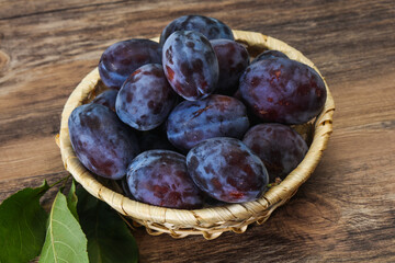 Ripe plum heap in the basket